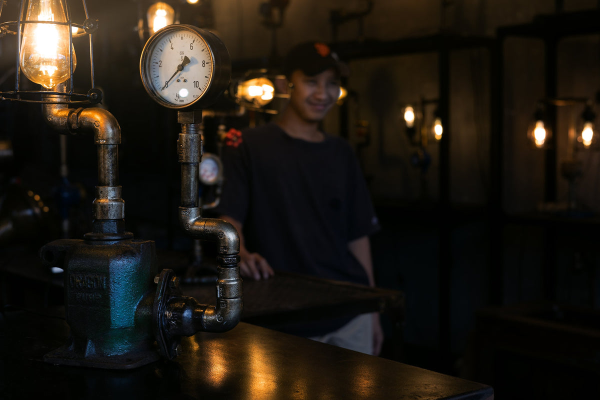 Railroad pipe lamp with pressure gauge in a dark room