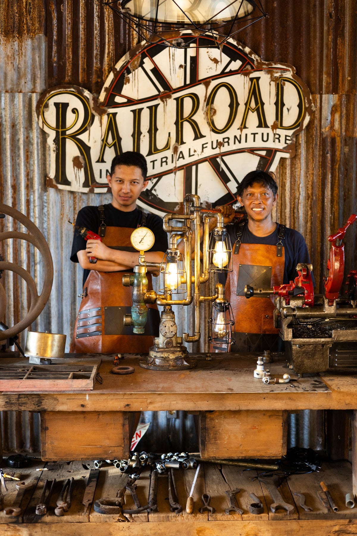 Two Railroad makers at the workbench under the Railroad sign